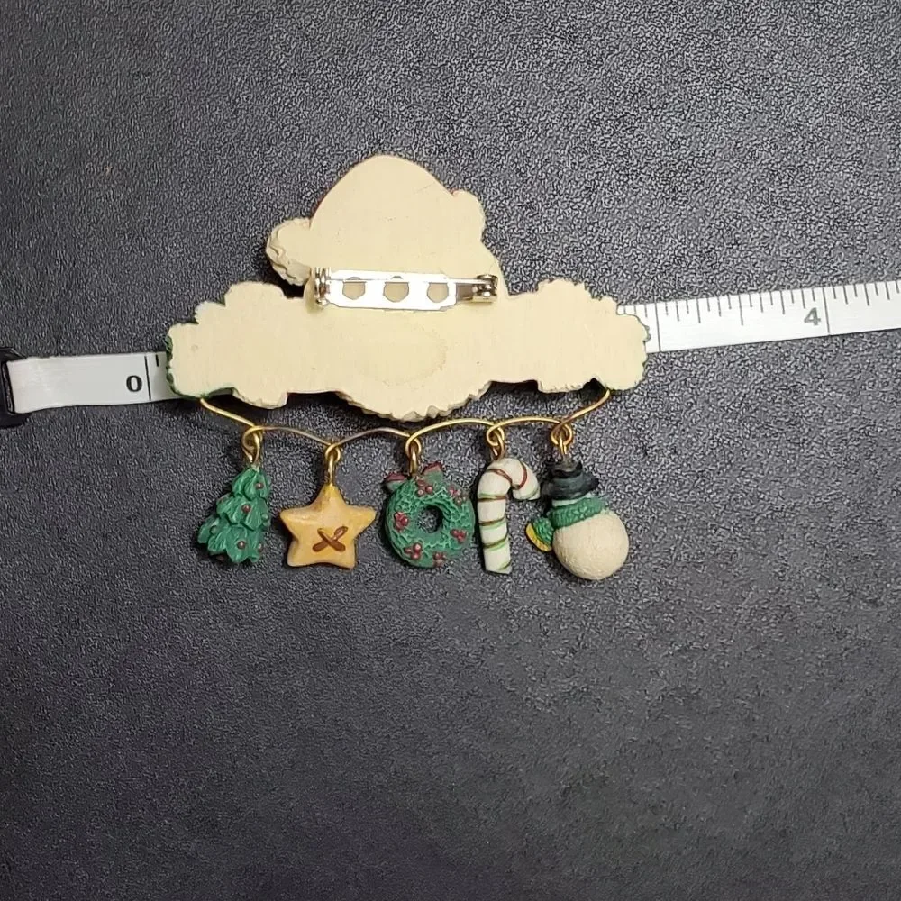Charm holding Santa holiday brooch